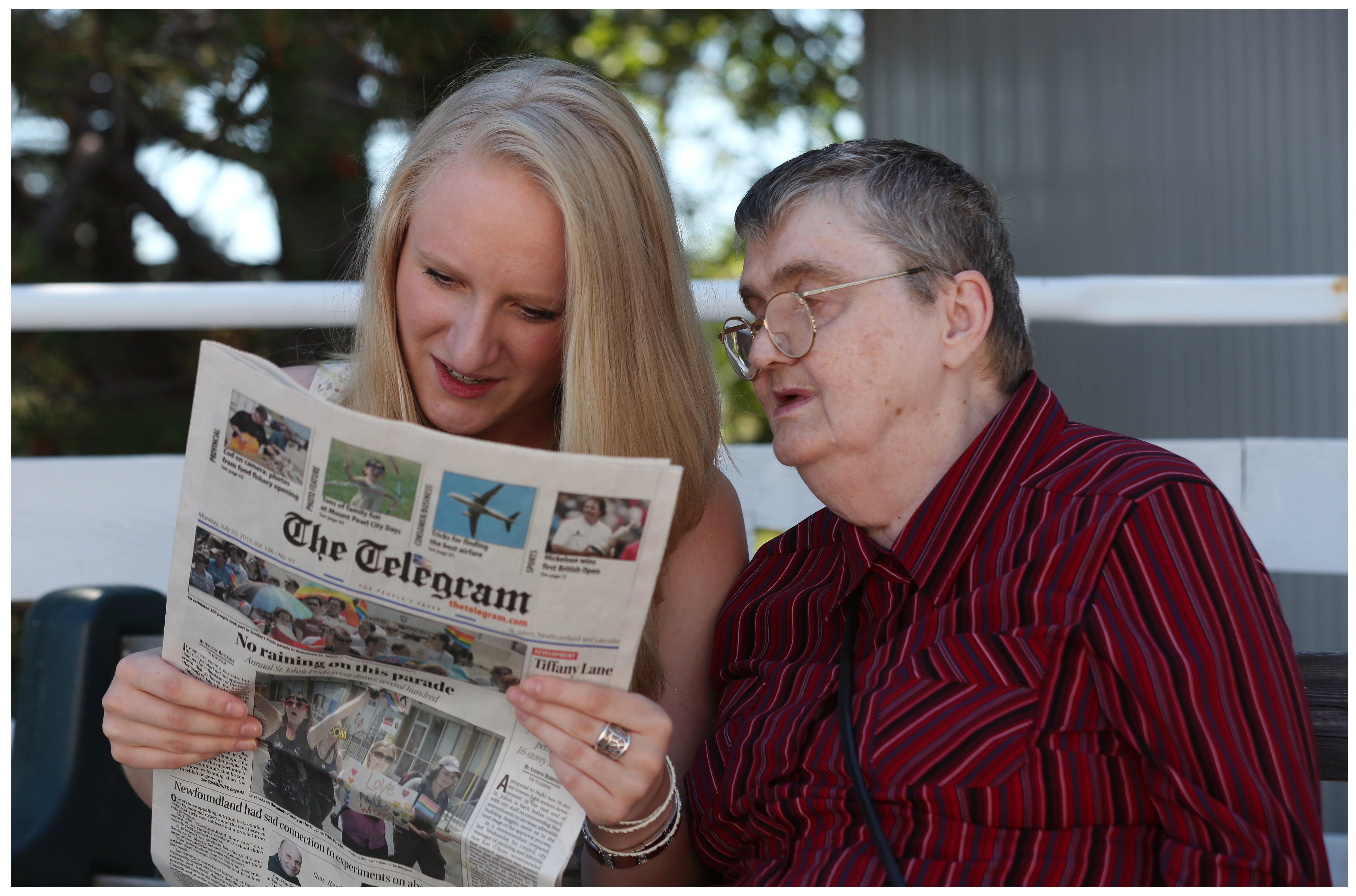Two people read a newspaper together